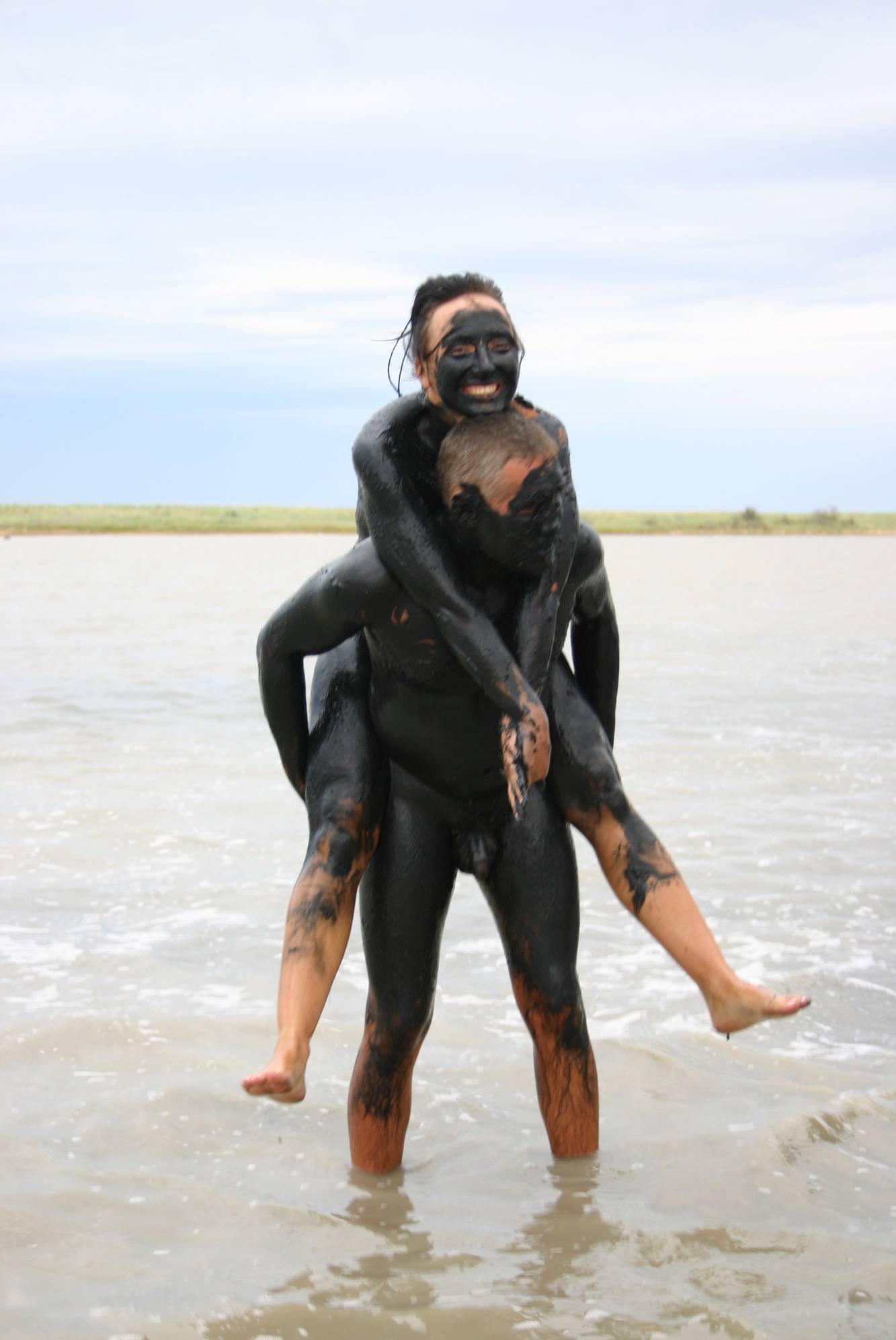 Embracing Nature with Black Mud-Paint Couples in Pure Nudism Photos - 2